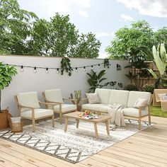 a living room filled with furniture on top of a wooden floor next to a tree