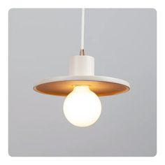 a white light hanging from a ceiling with a gray wall in the background and an image of a bulb on it