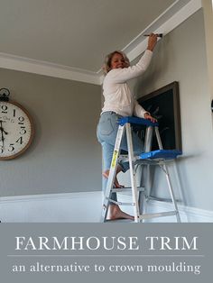 a woman standing on a ladder in front of a clock