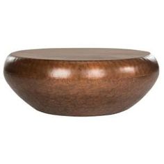 a wooden bowl sitting on top of a white surface