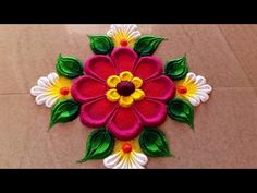 this is an image of a flower made out of felt and thread on the floor