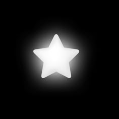 a white star is shining in the dark