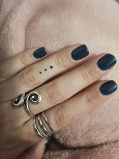 a woman's manicured nails and rings on her hand