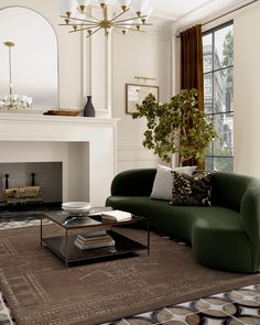 a living room filled with furniture and a fire place in front of a mirror on the wall