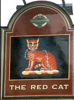 the sign for the red cat is hanging on the wall