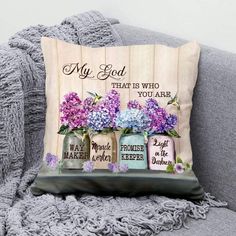 a pillow with three mason jars filled with flowers