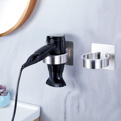 a hair dryer is hooked up to a wall mounted faucet in a bathroom