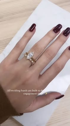 a woman's hand with a ring on it and a napkin in front of her