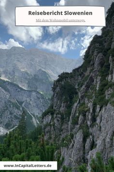 the mountains are covered with trees and rocks, under a blue sky filled with clouds