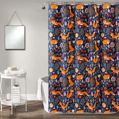 a shower curtain with an orange fox and flowers pattern on it, next to a white bath tub