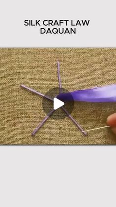 a video demonstrating how to make a silk craft law daquan with purple yarn