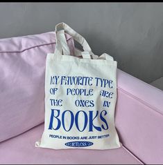 a tote bag sitting on top of a couch with the words, my favorite type of people are the ones at books