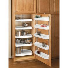 an organized kitchen cabinet with shelves for cooking utensils