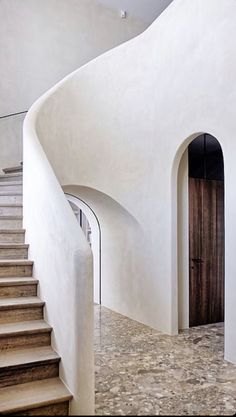 a staircase leading up to a door in a white building