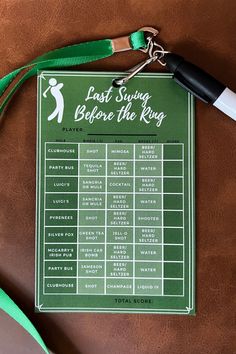 a green and white sign on a brown table with a lanyard attached to it