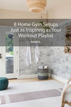 a gym room with white and grey walls, gray rugs and an exercise mat on the floor