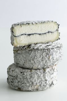 three different types of cheese stacked on top of each other, one white and the other gray