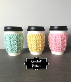 three coffee cups with crochet designs on them