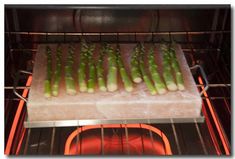 asparagus are being cooked in an oven