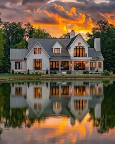 a large white house sitting on top of a lake