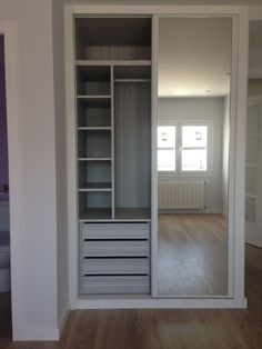 an empty room is shown with the door open to reveal it's own closet