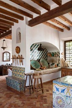 the kitchen is decorated with colorful tiles and wooden beams