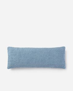 a blue pillow on a white background