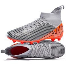 a pair of soccer shoes with orange and grey stripes on the upper part of the shoe