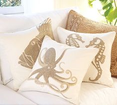 two decorative pillows with an octopus on them