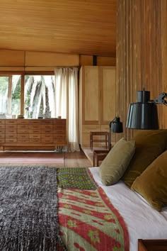 a bed room with a neatly made bed and a dresser