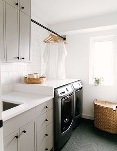 a washer and dryer in a white laundry room