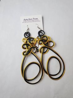 Beautiful black and gold colored aluminum wire wrapped  earrings are a totally unique design and are 4 inches long with hypoallergenic surgical steel earwires. Please come back and visit to check for new unique designs.  For more styles visit my Etsy shop: www.etsy.com/shop/SoftlySisterDesigns Adjustable Wire Wrap Drop Earrings, Black Wire Wrapped Metal Earrings, Wire Wrapped Metal Earrings For Party, Adjustable Wire Drop Earrings, Party Wire Wrapped Metal Earrings, Adjustable Gold Wrap Earrings For Party, Black Wire Wrapped Earrings, Unique Black Wire Wrapped Earrings, Unique Black Plug Earrings With Ear Wire