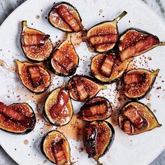 figs on a white plate with brown sugar and seasoning sprinkled around them