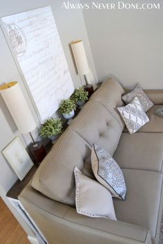 a living room couch with pillows on top of it