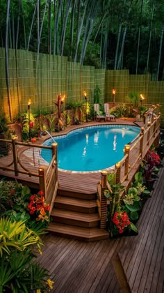 an above ground swimming pool surrounded by plants and trees with lights on the decking area