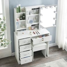 a white vanity table with drawers and mirror