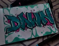 a drawing of the word dann in green, pink and blue ink on a piece of paper