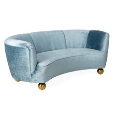 a curved blue couch with gold legs