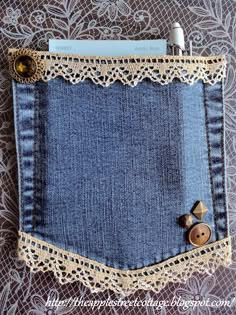 an old pair of jeans with lace and buttons in the pocket on a doily background