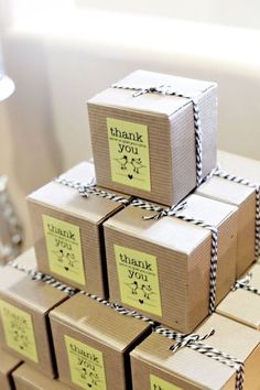 several boxes are stacked on top of each other with thank you notes attached to them