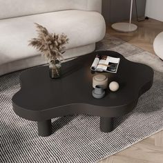 a black coffee table sitting on top of a rug