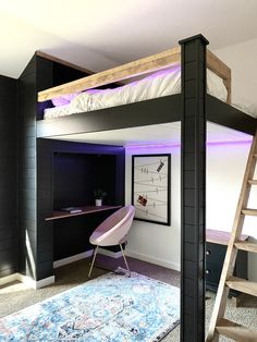 a loft bed with a desk underneath it and stairs leading up to the upper level