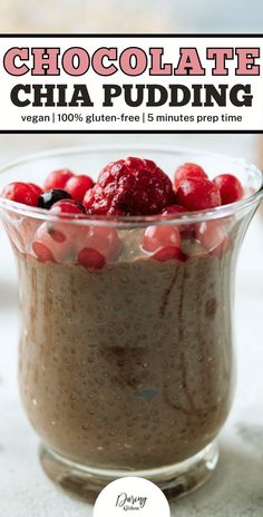 chocolate chia pudding in a glass bowl with raspberries and cherries on top