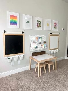 a child's playroom with two wooden tables and chalkboards on the wall