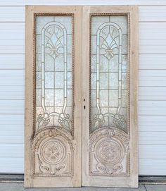 an old pair of stained glass doors on the side of a building