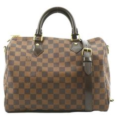 Item Details: Designer: LOUIS VUITTON Retail: N/A Model: Speedy 30 Bandouliere Material: Damier Ebene with Black Leather Trim Style: Satchel Shoulder Bag Color: Brown Made: France Date Code: AA3187 Made Year: 2017 Measurements: W 12" x H 9" x D 6.5" Accessories: Shoulder Strap. Condition Detail: Good - The Item shows signs of use, possibly including rubbed corners, moderate leather tanning, some inside stain marks, and tarnishing hardware. See the listing description for details. Outside: Signs Louis Vuitton Speedy 30 Bandouliere, Speedy 30 Bandouliere, Outside Signs, Leather Tanning, Speedy Bandouliere 30, Pre Owned Louis Vuitton, Trim Styles, Louis Vuitton Speedy 30, Shoulder Bag Brown