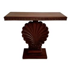 a wooden table with an intricate design on the top and base, against a white background