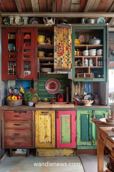 an old fashioned kitchen with colorful cupboards