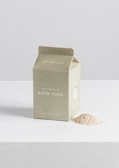 a box of bath soak next to it's contents on a white surface