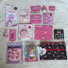 hello kitty items are laid out on the floor next to each other, including wallets and cell phones